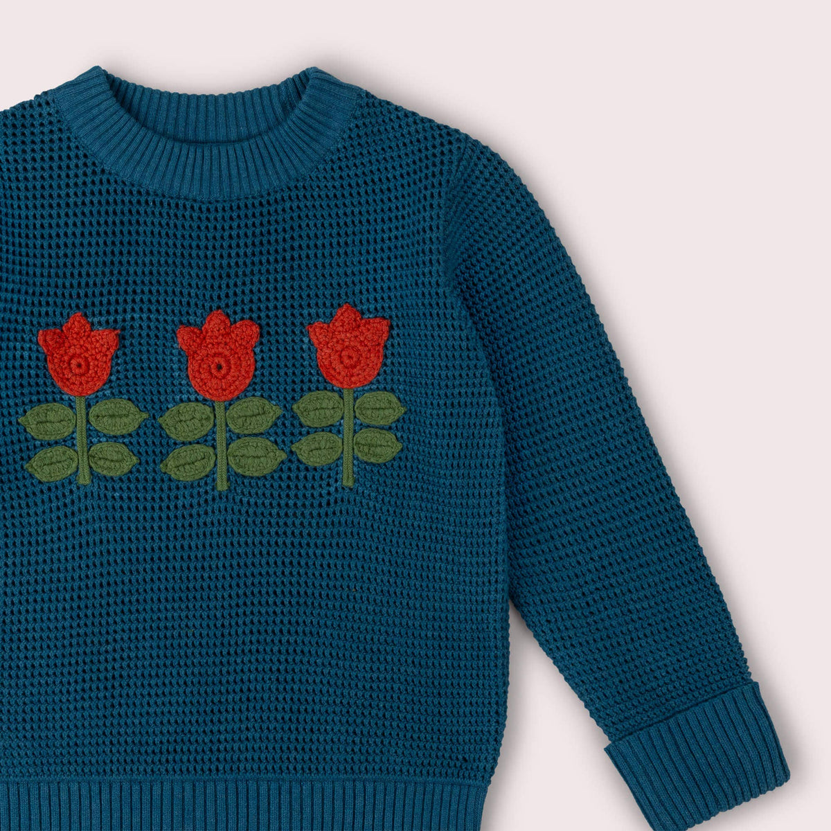 Blå strikkegenser med tulipaner