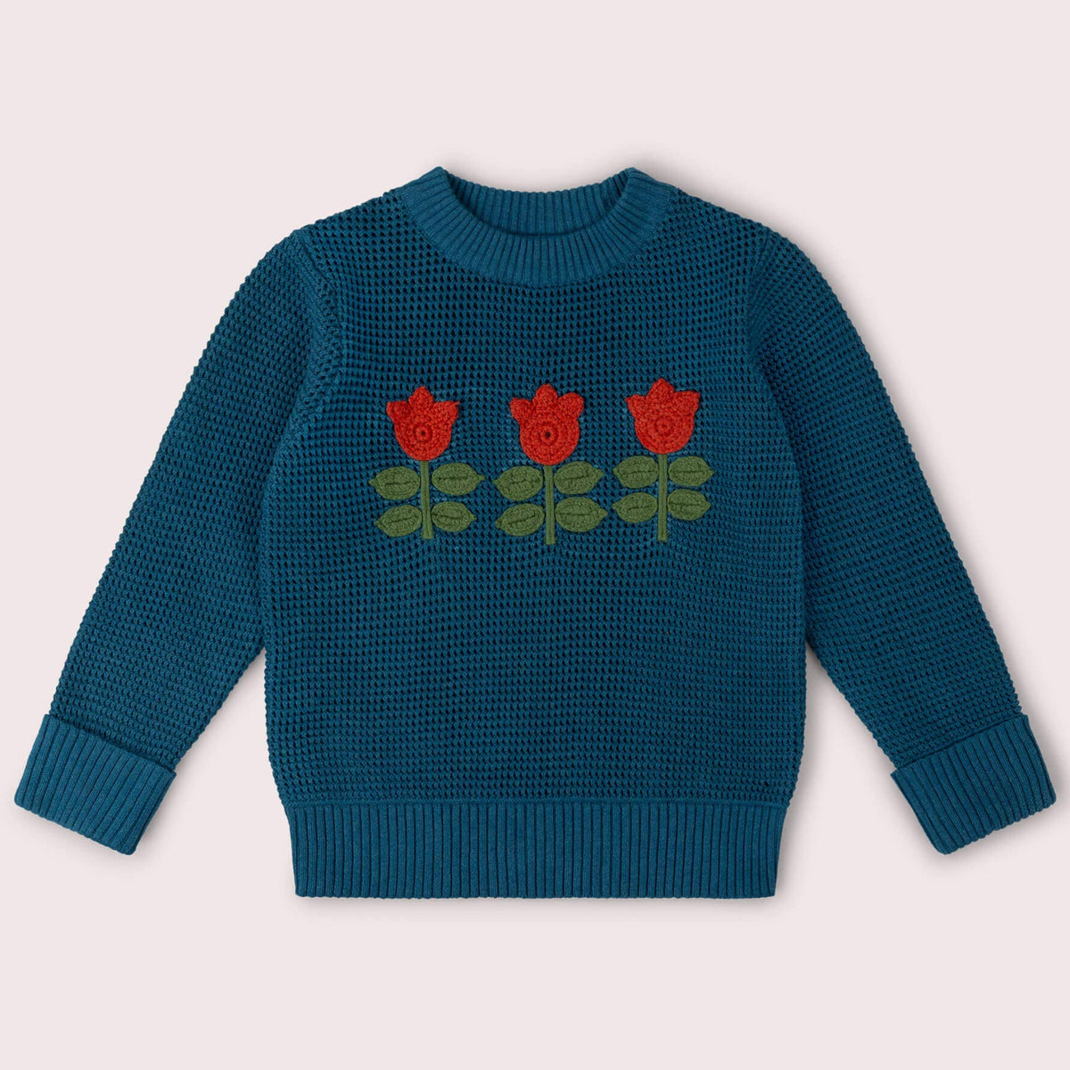 Blå strikkegenser med tulipaner